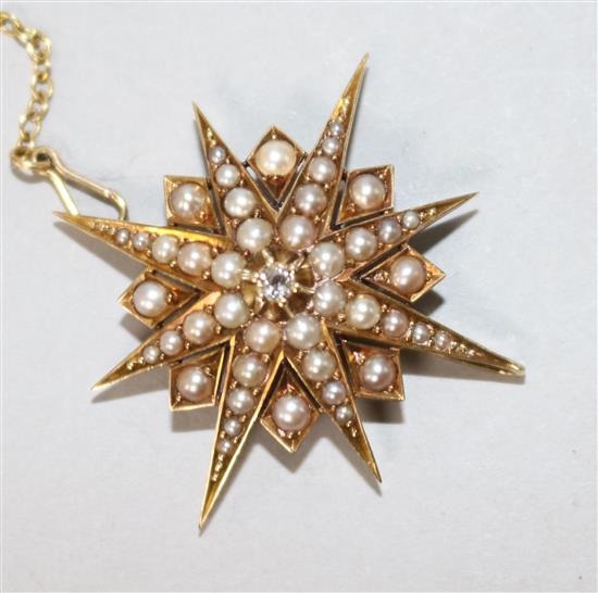 An Edwardian yellow metal, split pearl and diamond set starburst pendant brooch, 34mm.